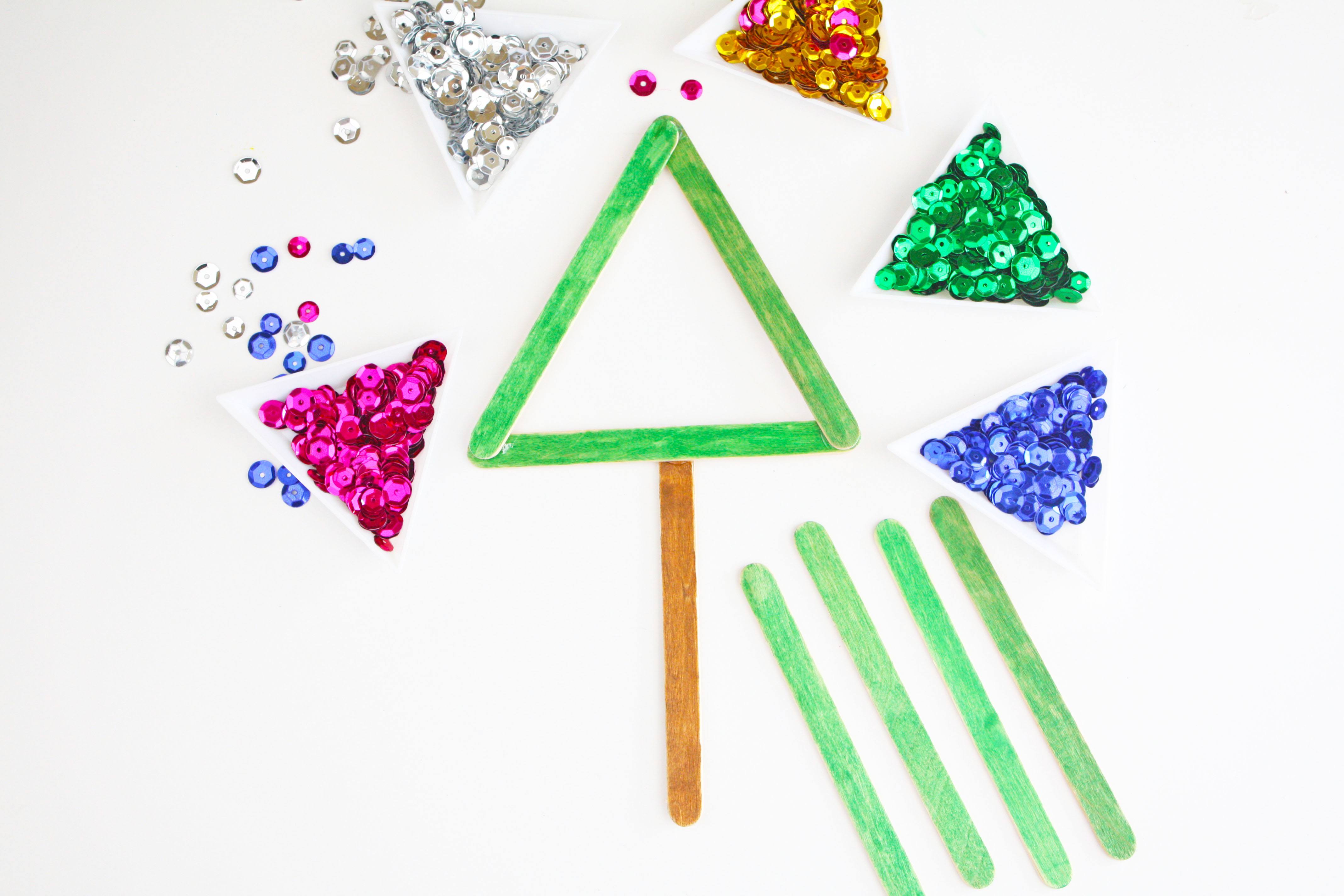 Learn how to make this easy and fun Popsicle Stick Christmas Tree Craft on Love the Day! It's the perfect craft to make with kids this holiday season.